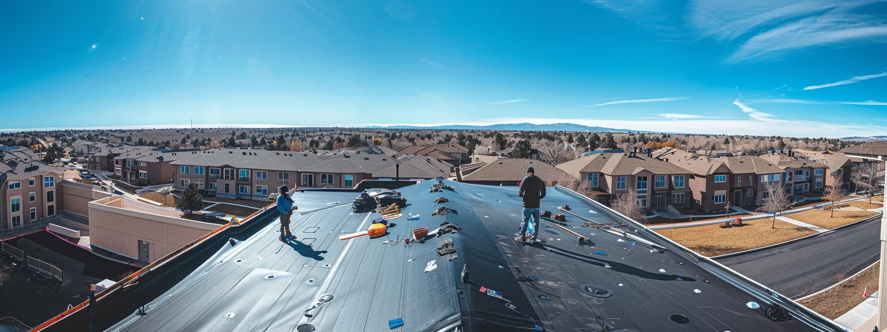 a legacy roofing crew working diligently on a rooftop in centennial co, showcasing their expertise in restoring wind and hail damage with eco-friendly materials.