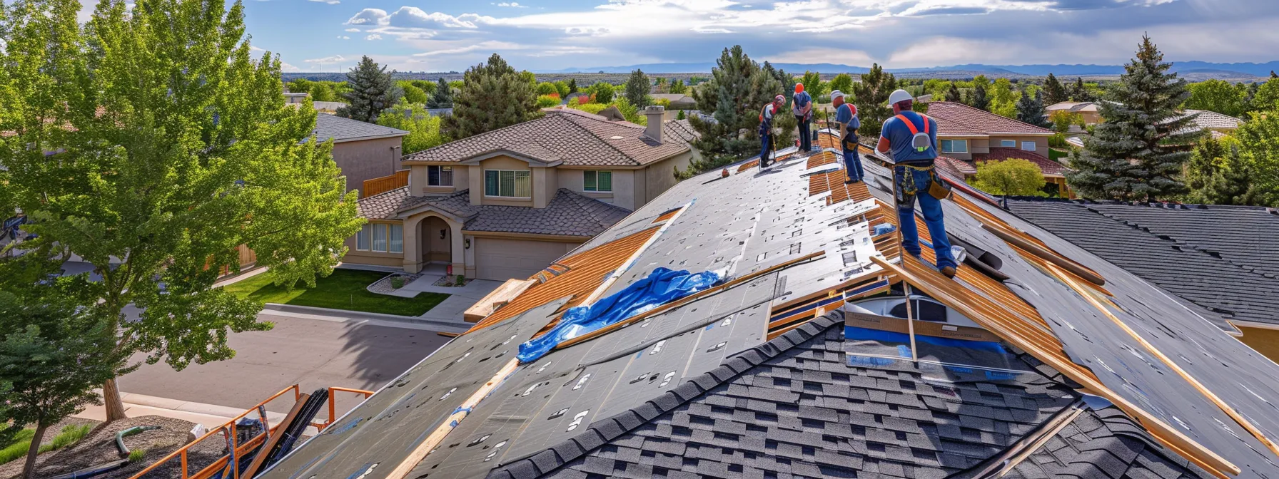 a team of professional roofers carefully installing new roofing materials on a building in centennial.