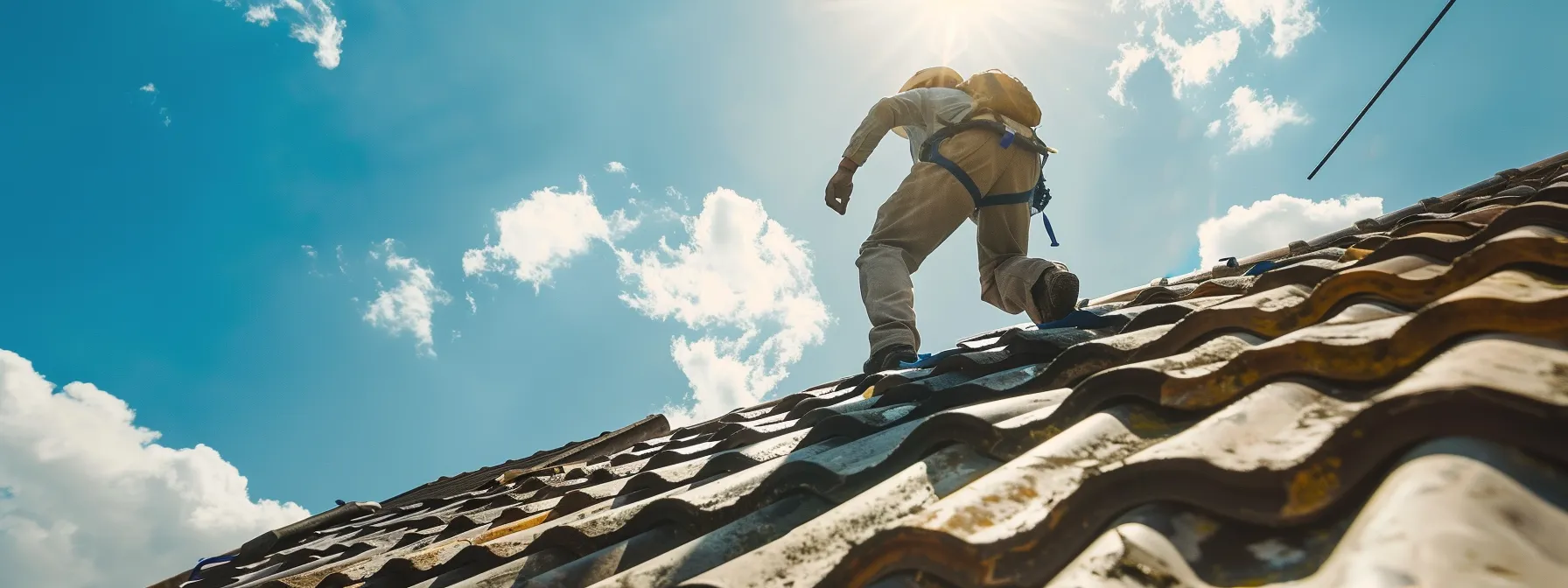 a person inspecting a roof for wear and damage.